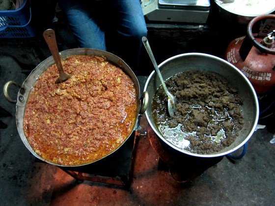 gallons of gajar and roasted semolina Halwa being cooked on the street